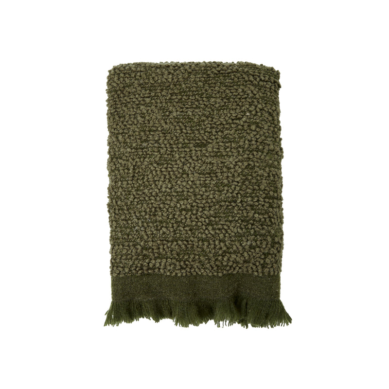 Deep green sofa throw with subtle fringe