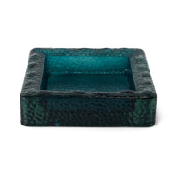 Teal sculptural square bowl styled on a coffee table
