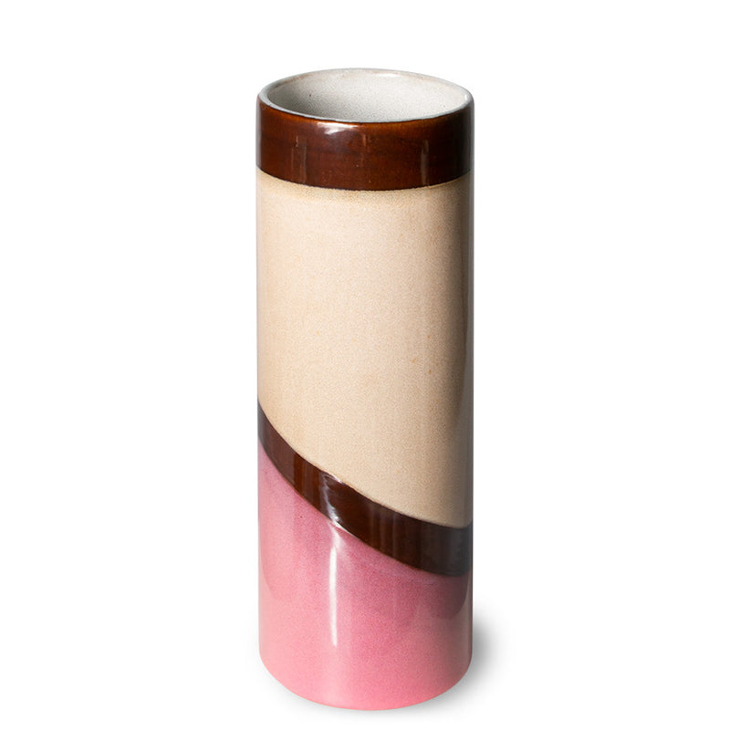 slight downward view of ths hklinvig vase with diagonal space of pink at the bottom rising to a line of brown  and swath of beige and topped with a level line of glossy brown