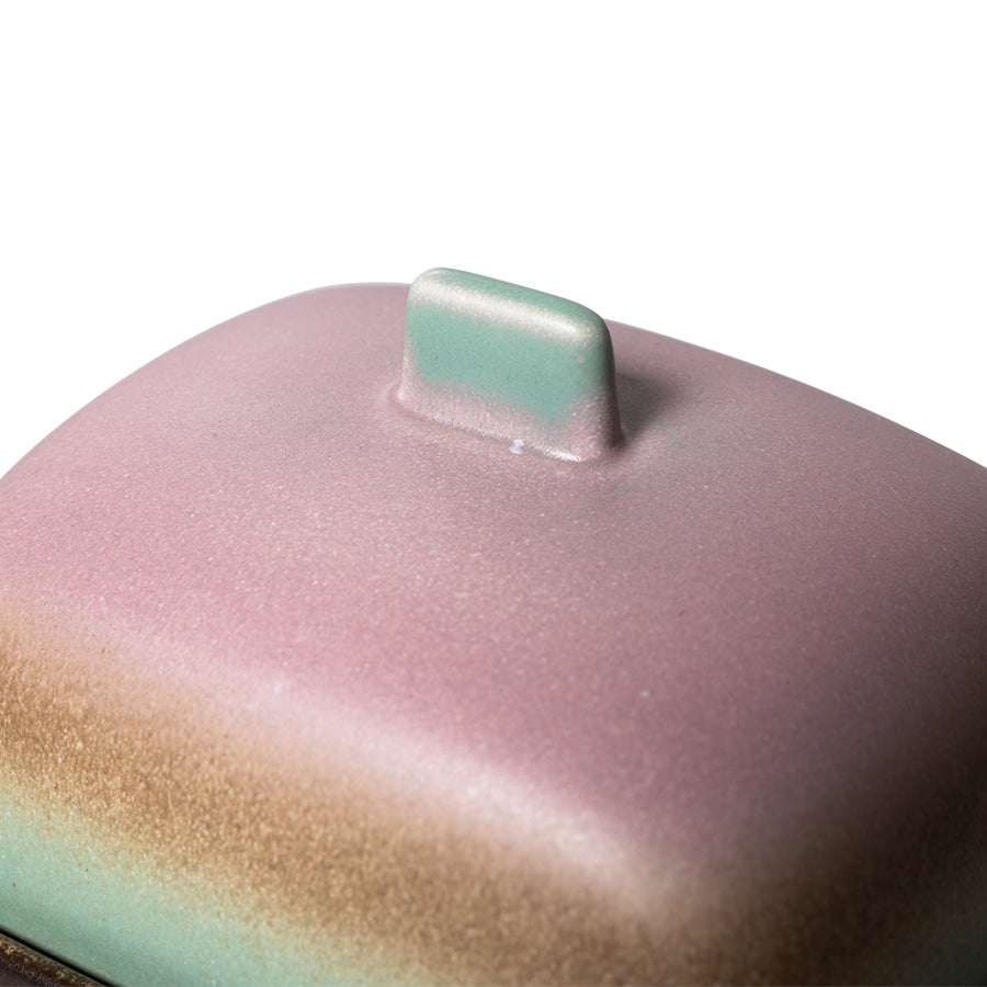 close up of the lid of the mercury butter dish's lid and its almost shimmering purple and green