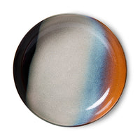 the almost other planetary coloured stripes of black, blue, orange of the inside of hklivnig bowl for serving