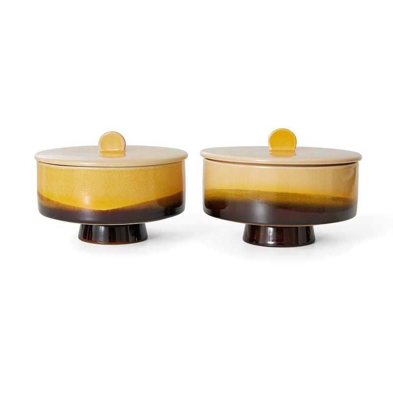 twin sunshine bonbon lidded jars next to each other showing off the almost sunset look of the design on them