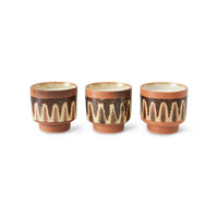 Three HKLIVING 70s Ceramics Kyoto scented candles in a row, terracotta pots with a cream and brown wave pattern