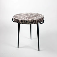 side view of the red marble side table with nordic home style by olson and jensen. the weight of the marble is easily supported by the elegant black iron legs