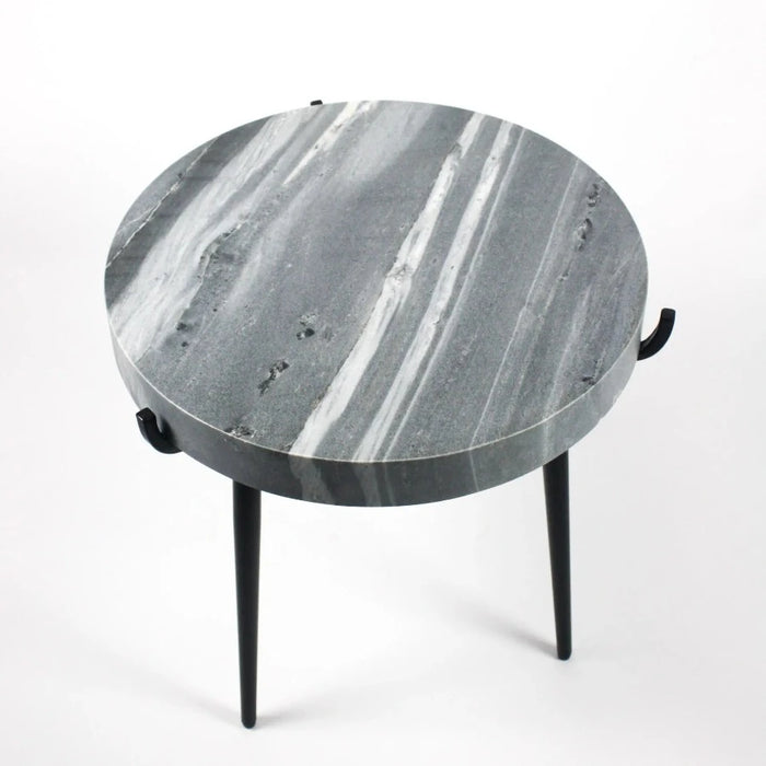 grey marble topped occassional table looks almost like a black and white image of jupiter with its veins and swirls of white and black. its black iron tripod legs give the end table makes this distinctly nordic design from olsson and jensen