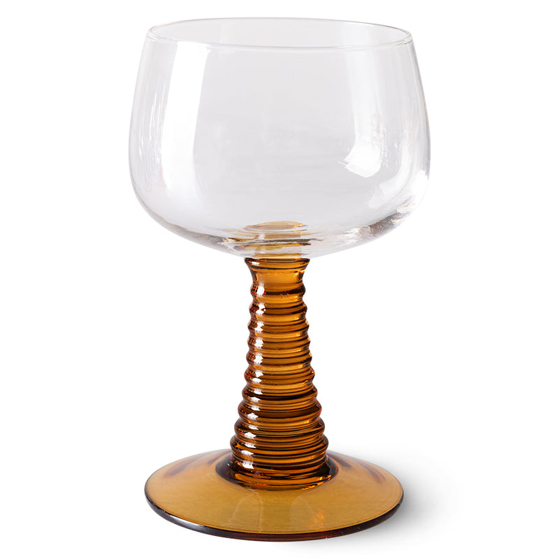 hkliving wine glass with a swrily cone shapoed stem and base in a burnt orange colour