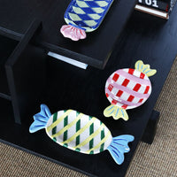 collection of colourful candy-shaped ceramic plates in assorted sizes and patterns by &k Amsterdam
