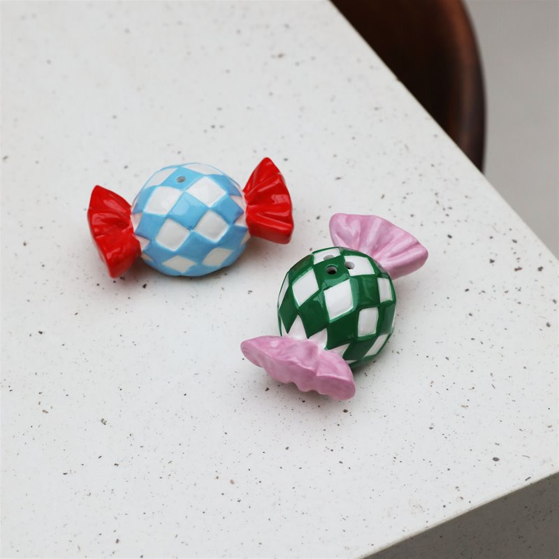 colourful candy-shaped salt and pepper shakers in check print adding playful charm to a dining table
