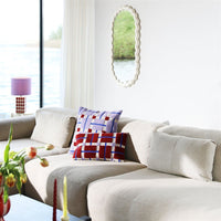 multicolour rectangular plano cushion by &k Amsterdam styled on a neutral sofa
