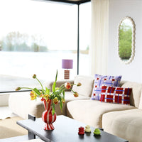 ed and cream geometric ceramic lamp with purple shade by &klevering styled in modern living room
