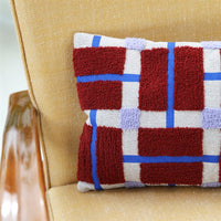 close-up textured tufted plano cushion in red blue and lilac by &klevering

