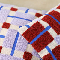 close-up of textured hand-tufted cotton cushion in lilac, red and blue by &klevering
