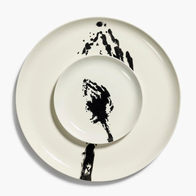 small side plate from ottolenghi with a print of a black globe artichoke on an off white plate