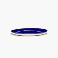 side view of the deep blue dinner plate from ottolenghi showing the unglazed underside perfect for dinner parties and feasts with friends