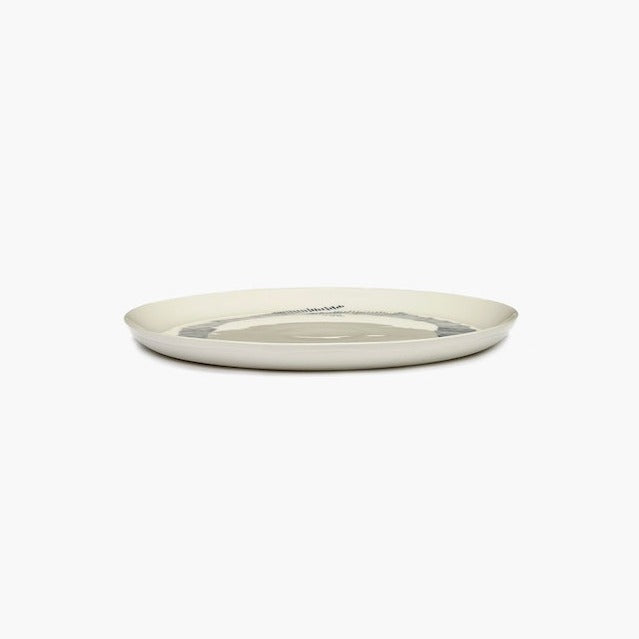 side view of the off white plate wiht black stripes from ottolenghi by serax feast range with a luxurious level of glaze