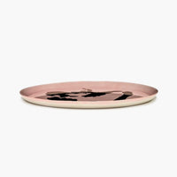 side view of the large serving plate for any feast or dinner party with friends in delicious pink with the ottolenghi golden bell pepper barely showing over the top of low lip