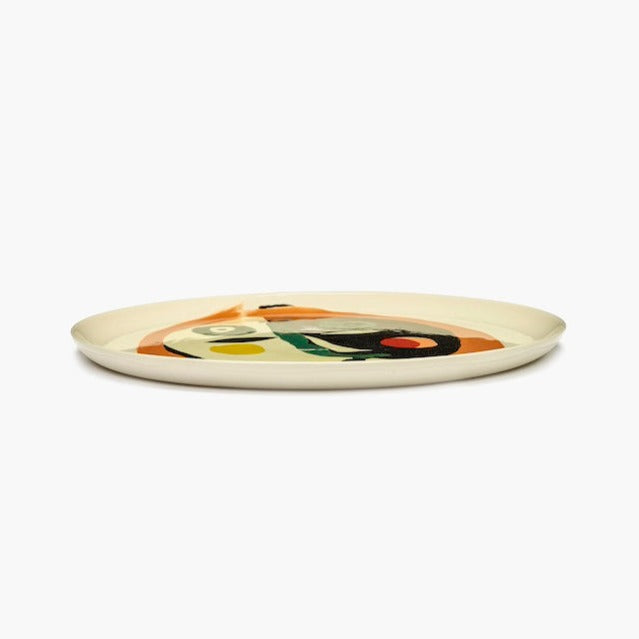 side view of the face motif by ottolenghi large serving plate reveling in its handpainted joy and bringing a flash of colour to every dinner party with the qulaity of serax tableware