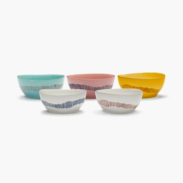 set of bowls from Yotam Ottalenghi range of colourful crokery and tablewear with azure blue, pink, sunshine orange, and off white all with contrasitng short broush coloured stripes going down in a wave around the outside of the bowls