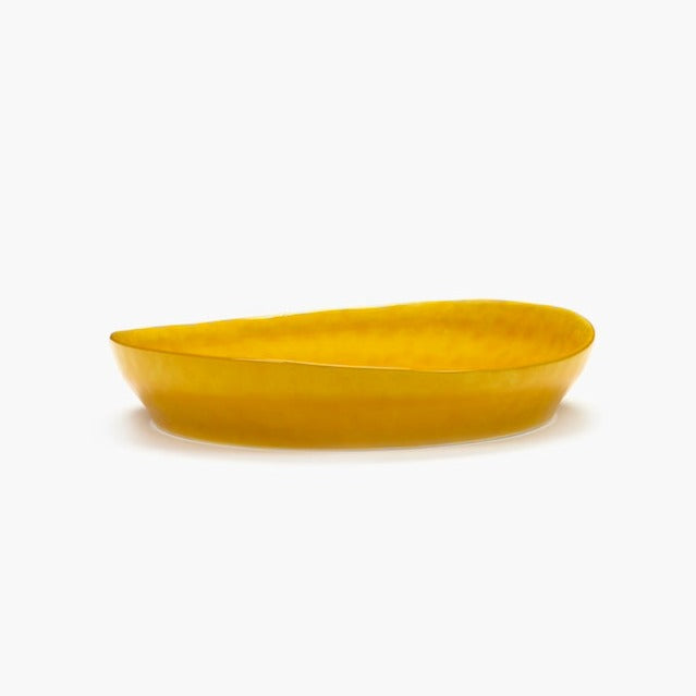 with glorious wave to the top of a sunshine yellow serving dish from serax and ottolenghi