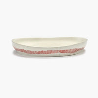 side view of the off white with red stripes deep serving dish perfect dinnerware with friends in the style of ottolenghi and showing quality of serax