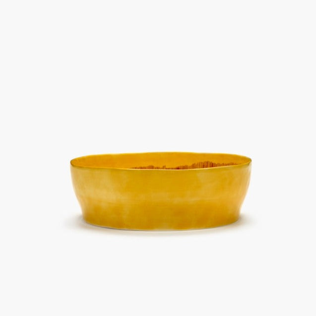 salad serving bowl by ottolenghi and serax in a glourious yellow and red stripe with a high side and deep glaze