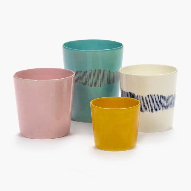 a collection of different sized cups and mugs from the ottolenghi design in cluding a taller azure blue mug and deliciously pink cup and a small sunshine yellow espresso cup