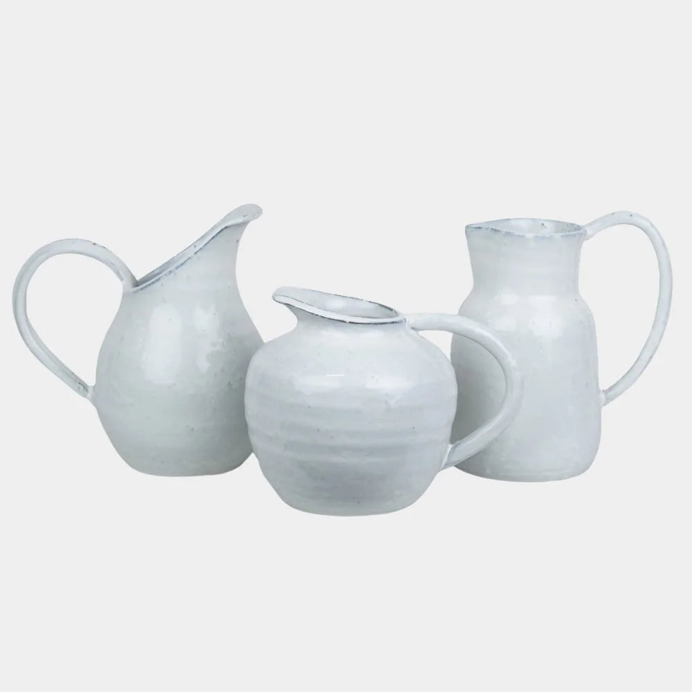 3 white glazed jugs in different styles handmade in a rough style