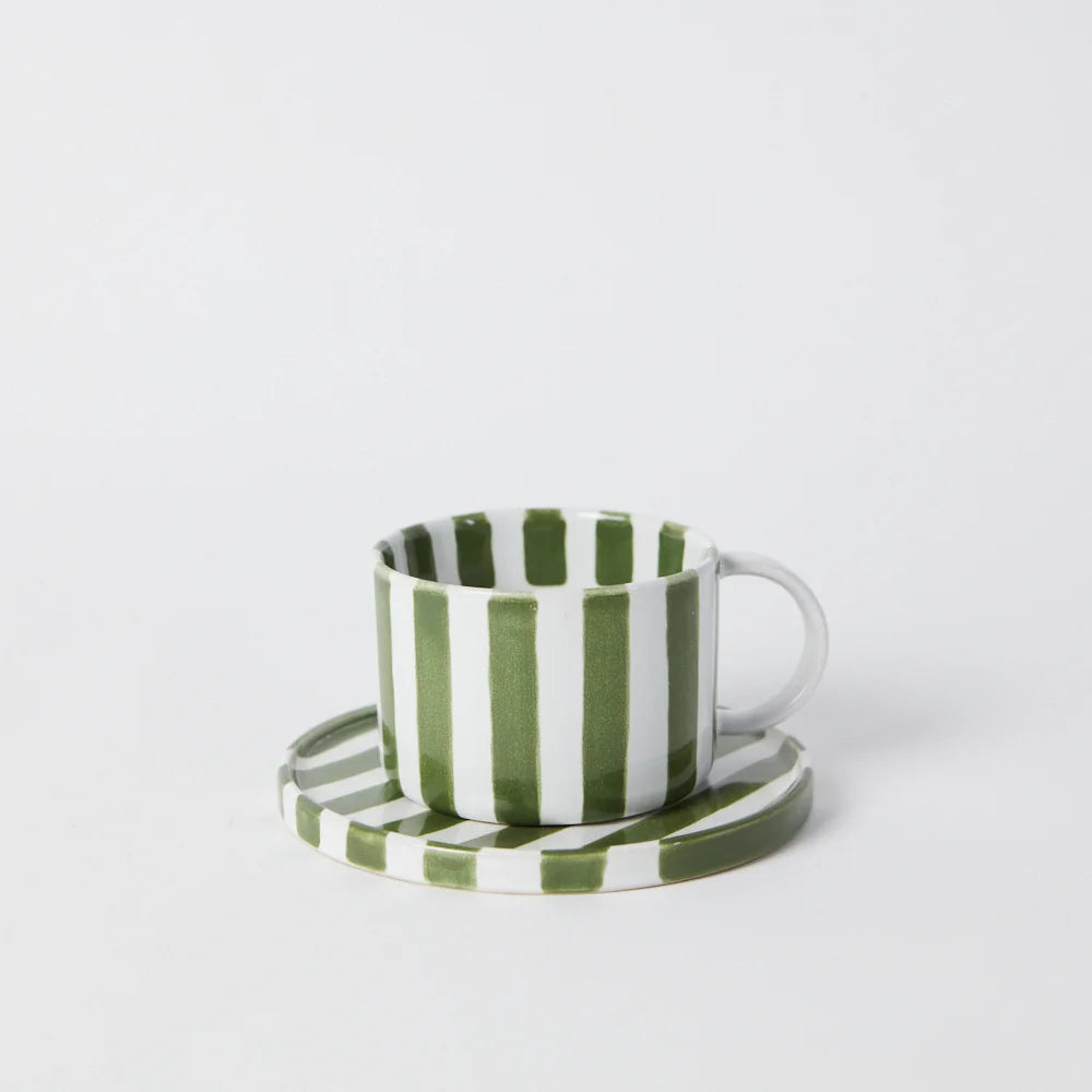 coffee cup  with handle on a saucer in whte and green stripes 