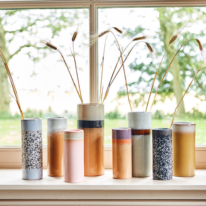 different coloured 70s collction hkliving vases standing on a windowsill