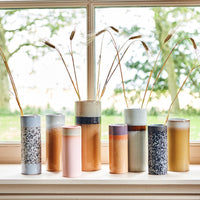 different coloured 70s collction hkliving vases standing on a windowsill