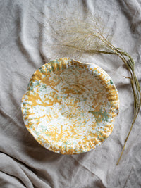 Large terracotta bowl with painterly yellow and green splatter