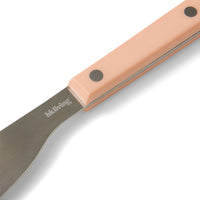 Close-up of a peach HKLIVING 70s Cutlery knife handle with rivet details