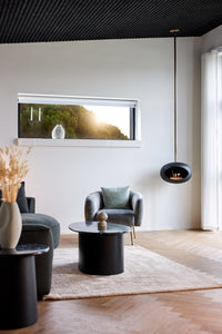 Black Le Feu Sky designer fireplace suspended from ceiling in open-plan living room