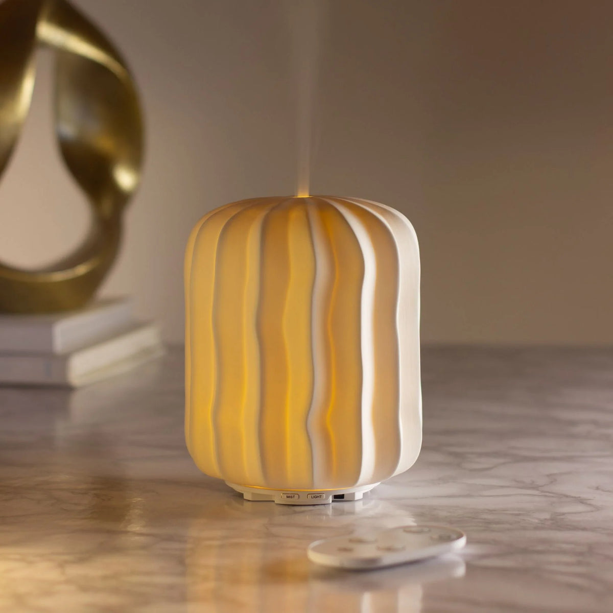 sculpted ceramic aroma diffuser with soft warm glow and remote control