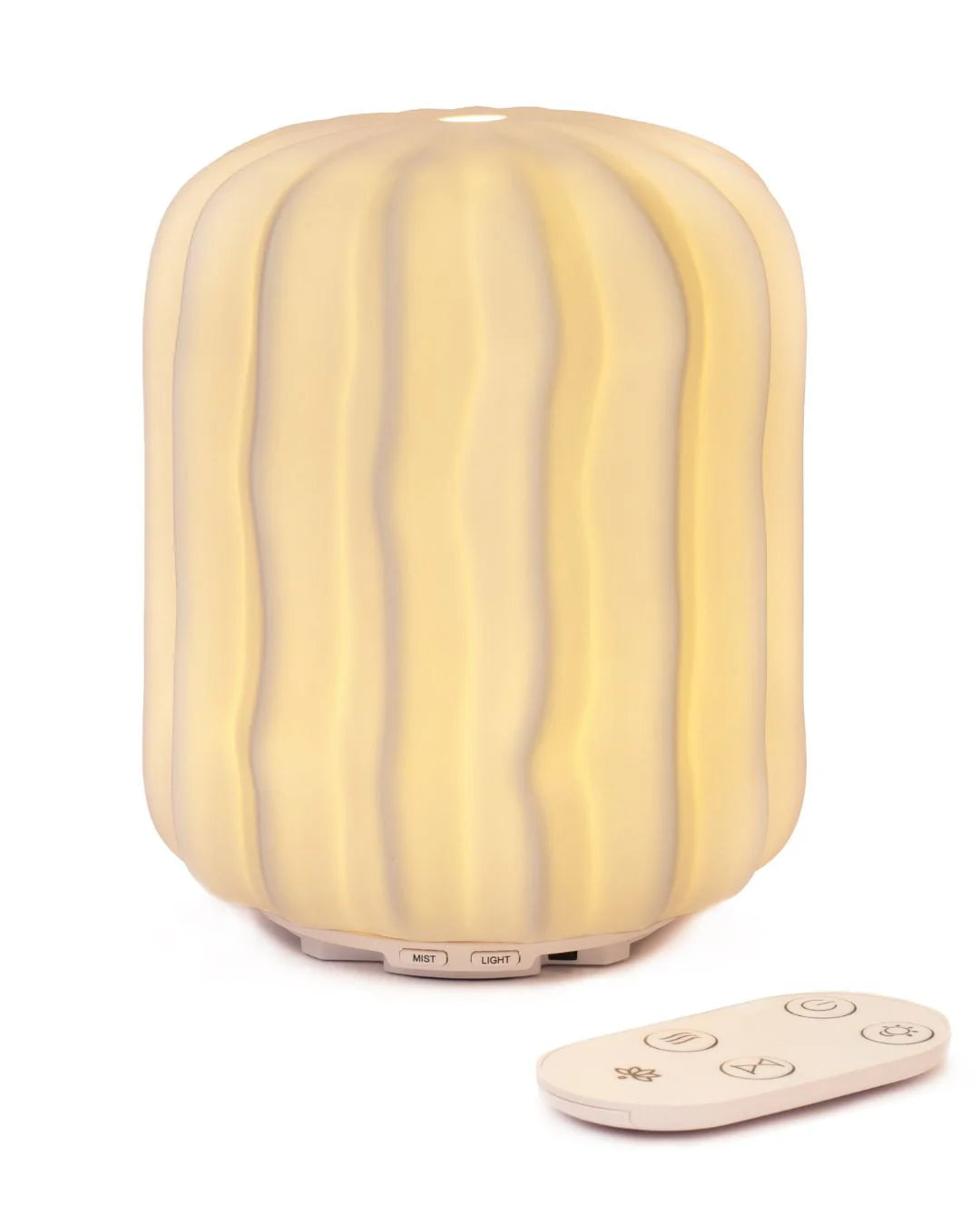 Lina ceramic aroma diffuser glowing on marble surface with remote
