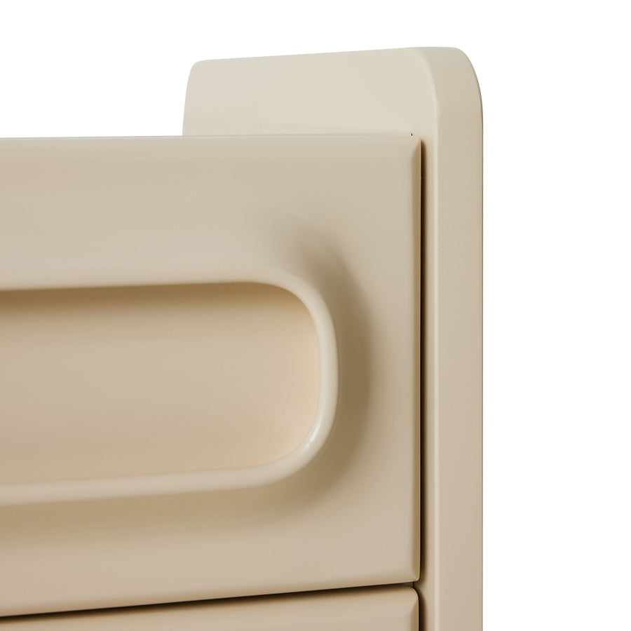 Angled close-up of the cream Space Nightstand by HKLIVING, showing the rounded drawer handles and top corner