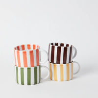 4 stacked striped handled coffee cups in orange, burgundy, green, and yellow