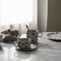 some of the green spotty collection on a grey marble table