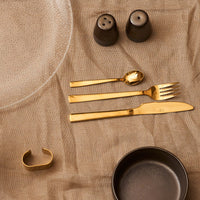 Metallic brown ceramic shakers with reactive glaze on a dining table