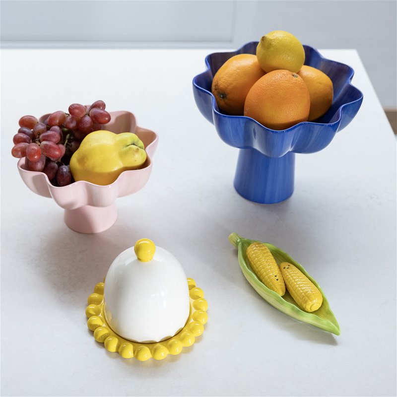 pink sun bowl and blue pedestal bowl displayed with fresh fruit for colourful kitchen styling
