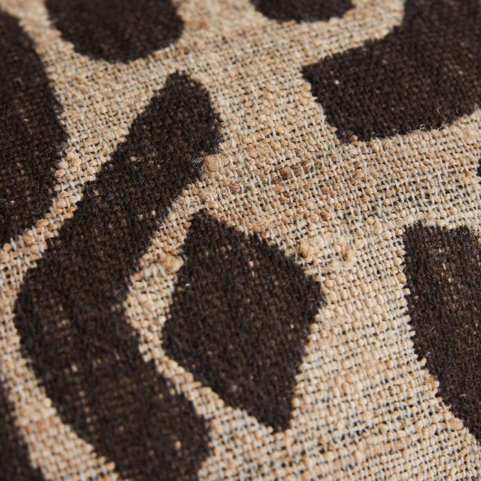 close up of the fabric of a cushion really showoing the weave and deep brown and beige