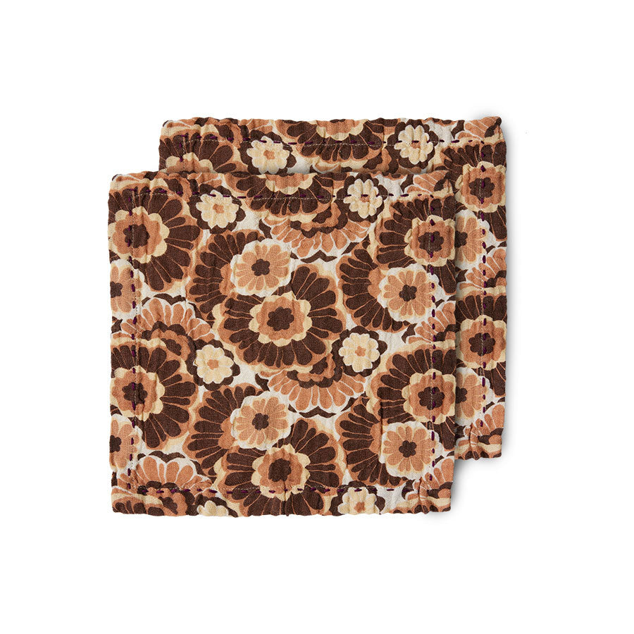 pair of cloth napkins in a orange brown floral design with heavy handed, thick stiching a half inch from the edge which doesn't detrat from teh overall soft look from hkliving