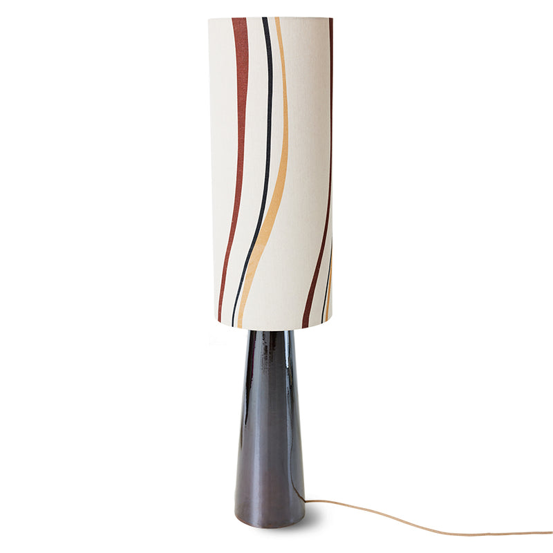 the full length floor lamp with a black lamp base that rises up with a slight taper, and the off-white,, yellowish lamp shade that isn't stripy but does hace a few complimentary, slightly wavy stripes down it in red, black, and yellow