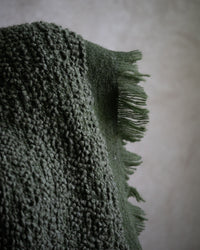 Earthy green throw with textured weave