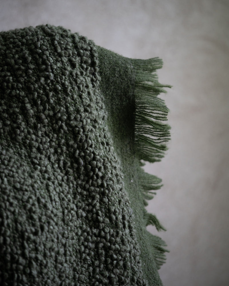 Earthy green throw with textured weave