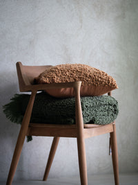 Nalia green boucle throw styled with rust cushion