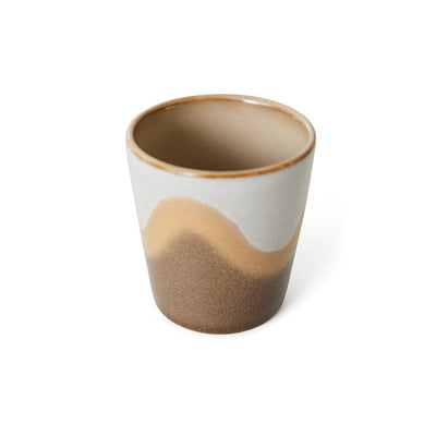 with waves forming around the outside in brown, beige, and grey and a light brown inside in a less bright version on this 70s ceramics coffee cup from hkliving