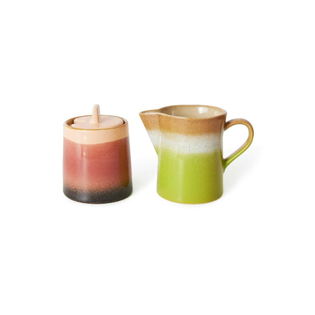 the hkliving sugar por has is deep brown at the bottom, with the main central part a reddish pink and the lid and top band a light pink. The milk jug is a light grass green on the bottom half raising through a stripe of beige and and light brown round the top