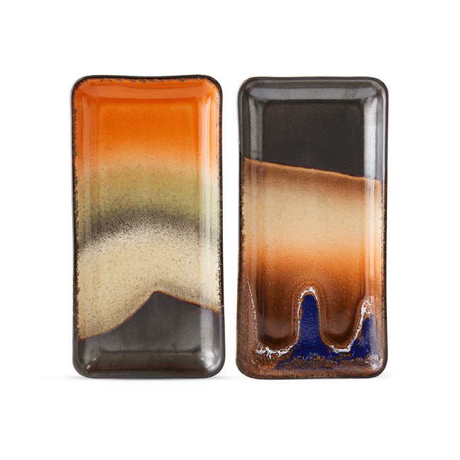 hkliving ceramic trays in gorgeous 70s colours with one looking like a moutain with a sunset in the background and the other with the sea washing up on a sand dune at night. with rough edges to the colous  and elongated style