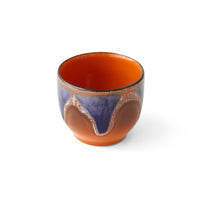 hkliving arabica colour design includes blue purple heavily dripping down the outside with a brown undercoat and bright orange interior to this mug